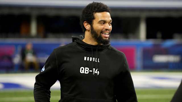 Caleb Williams looks to the side smiling at the combine